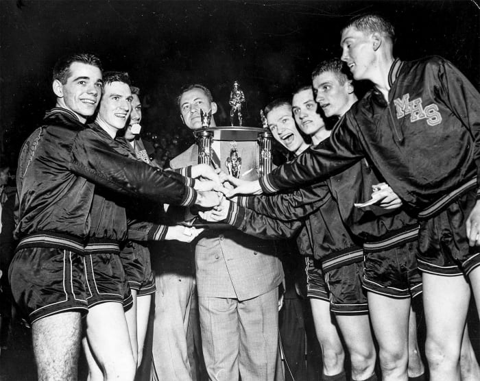 Bobby Plump (second from right) and Milan High School celebrate their 1954 championship